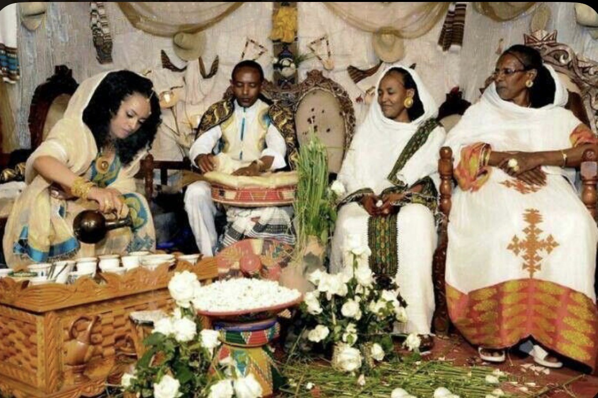 An Ethiopian coffee ceremony with traditional dress and woven serving pieces